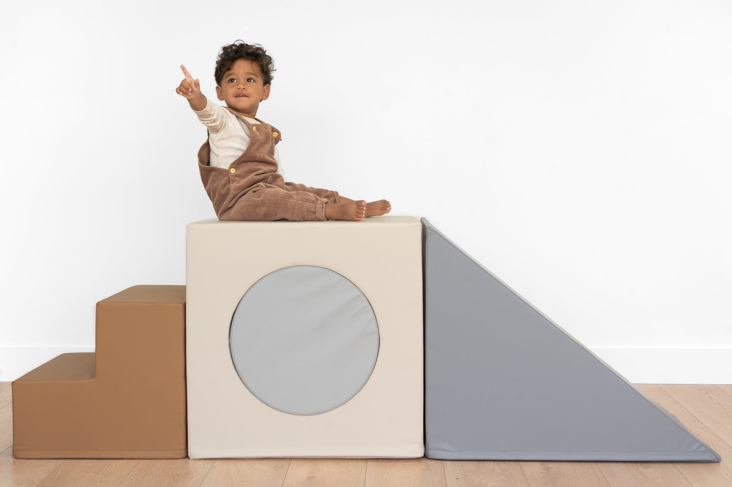 north&nova vegan leather foam playset climber front view with pointing kid  slate