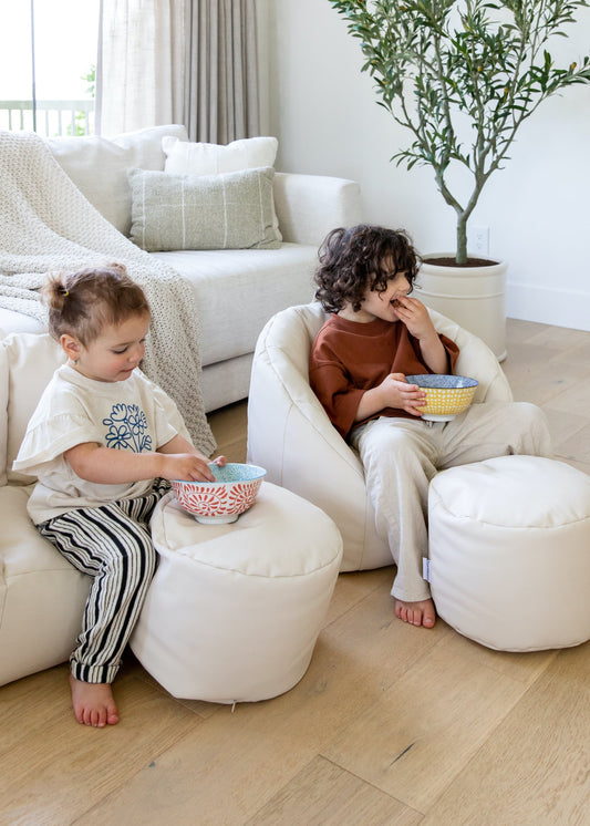 Two kids sitting on north&nova's Pouf
